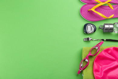 Photo of Flat lay composition with swimming accessories on green background. Space for text