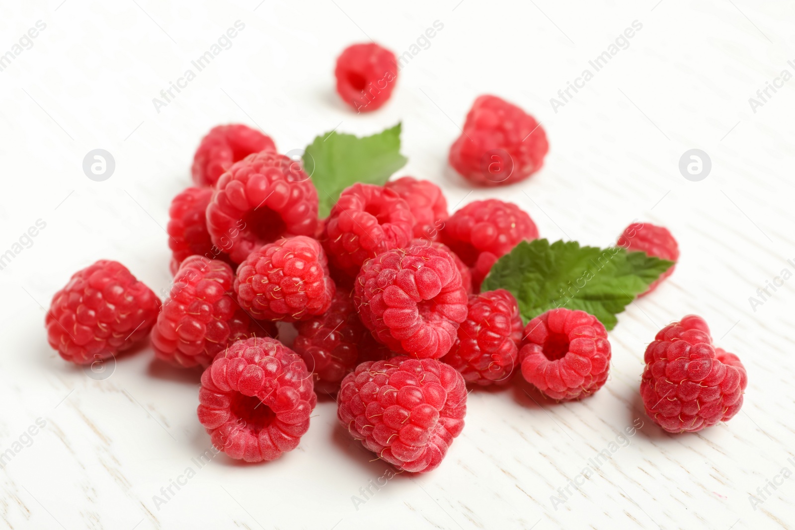 Photo of Ripe aromatic raspberries on table, closeup