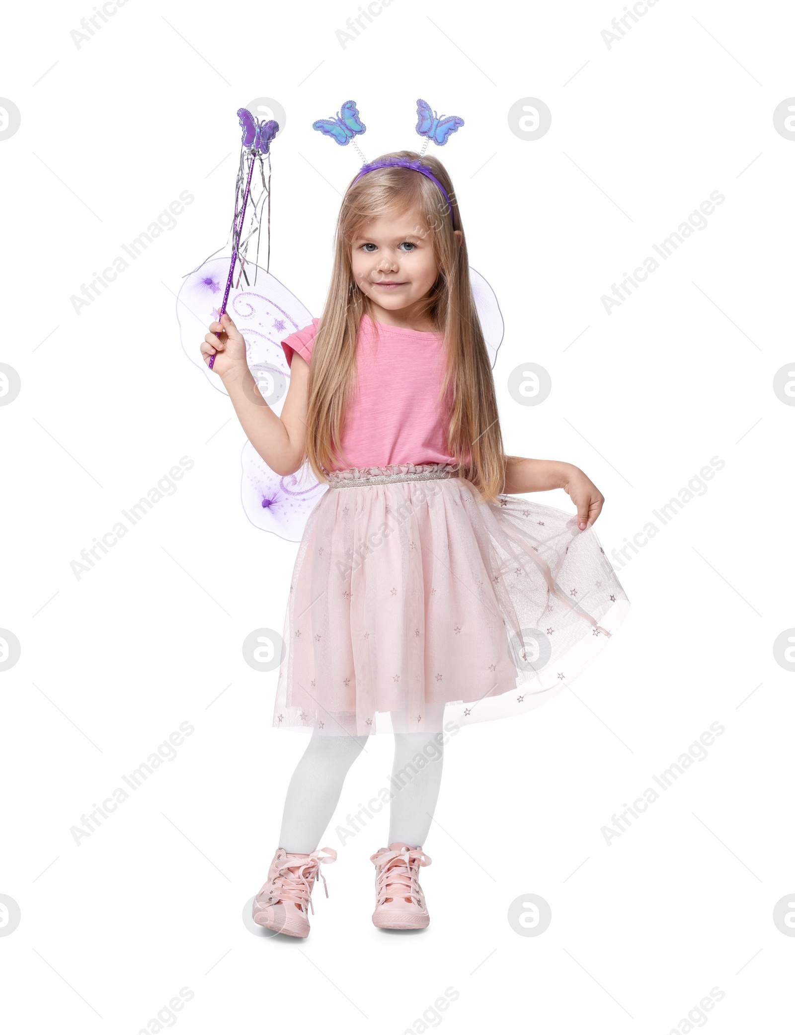 Photo of Cute little girl in fairy costume with violet wings and magic wand on white background