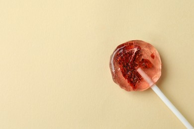 Sweet colorful lollipop with berries on beige background, top view. Space for text