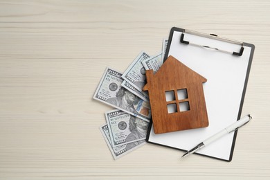 Photo of Mortgage concept. House model, clipboard and money on white wooden table, flat lay with space for text