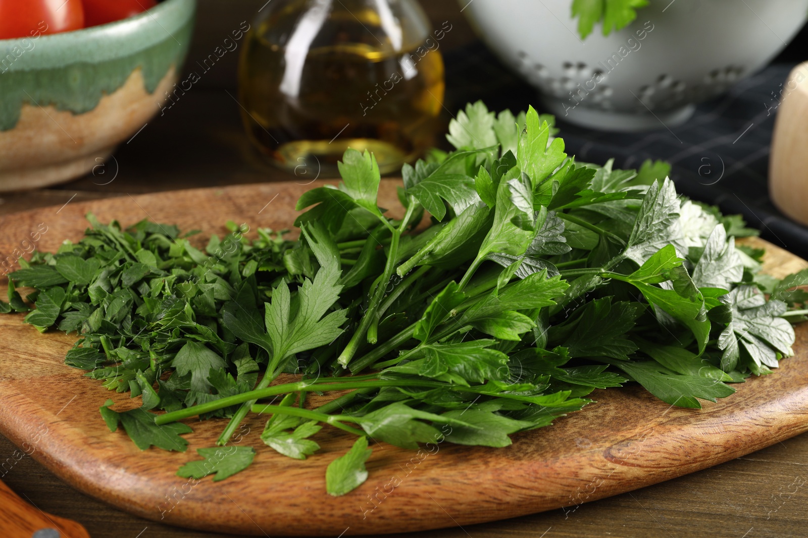 Photo of Fresh green parsley on wooden table, closeup