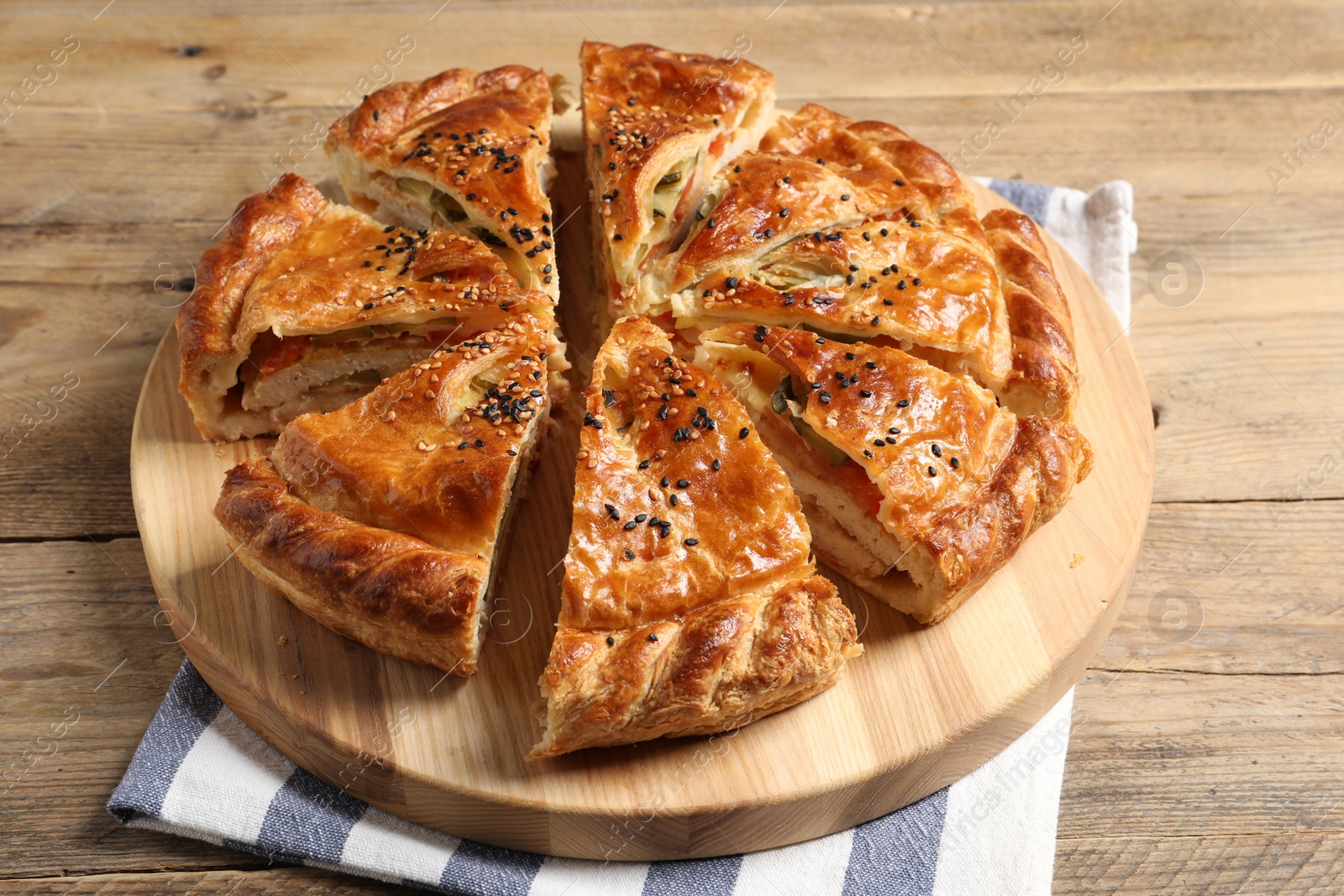 Photo of Cut delicious homemade pie on wooden table