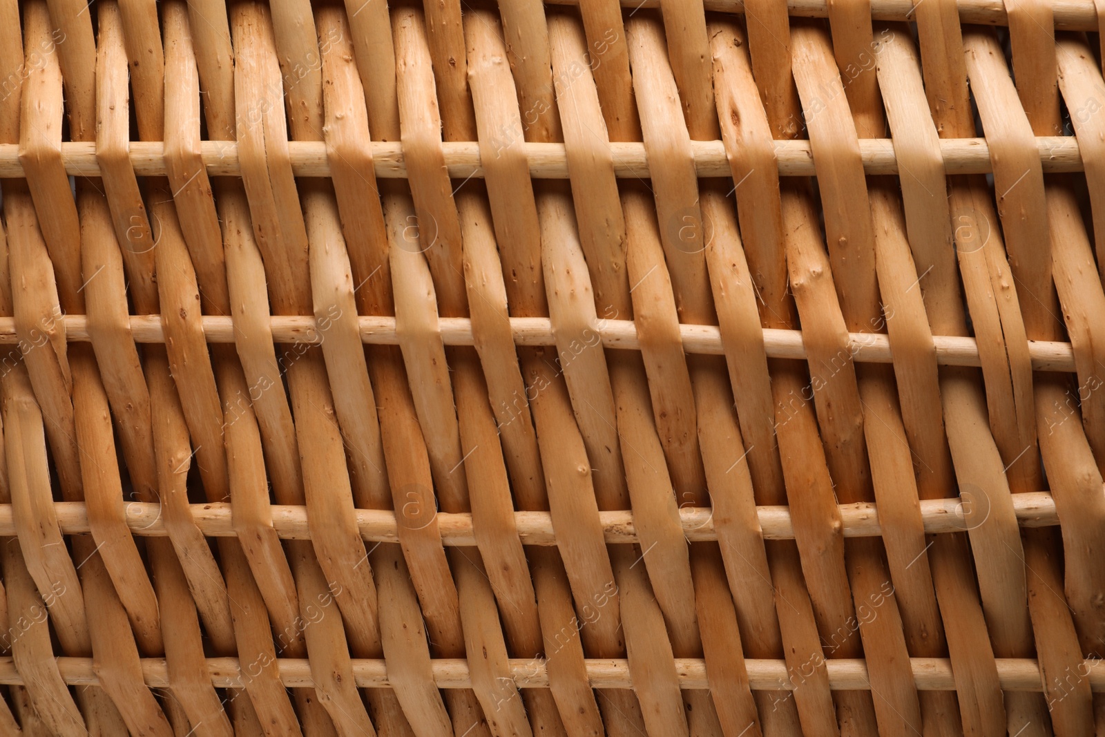 Photo of Handmade wicker basket made of natural material as background, closeup view