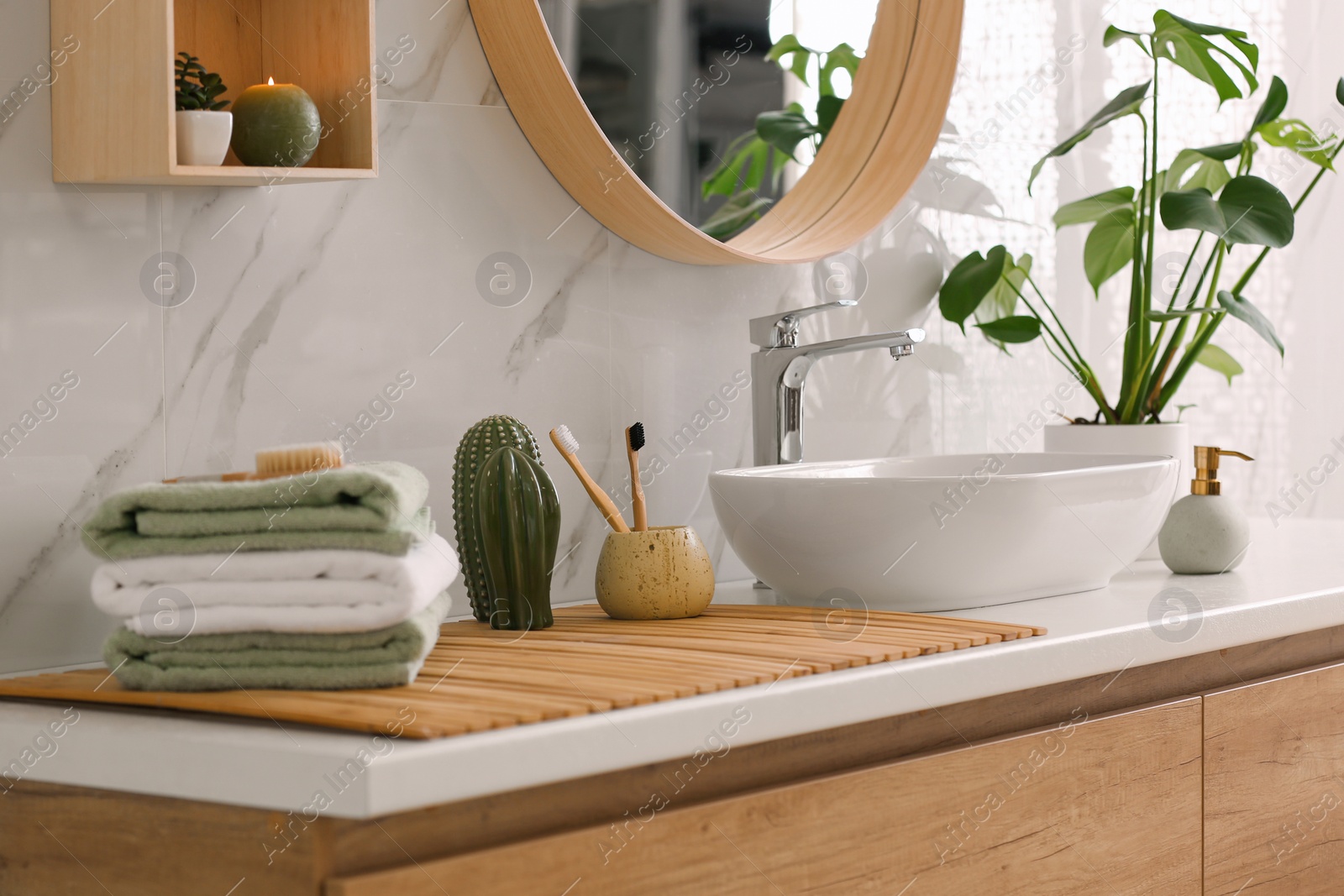 Photo of Stylish vessel sink on light countertop in modern bathroom