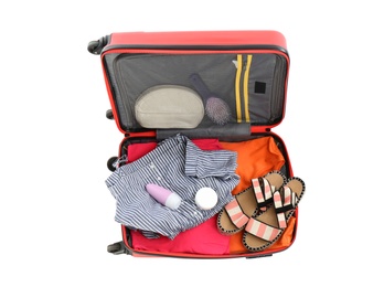 Photo of Packed suitcase with deodorant and clothes on white background, top view