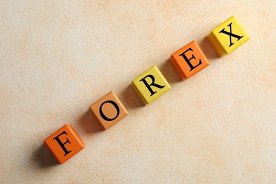 Photo of Word Forex made with colorful cubes on light table, flat lay
