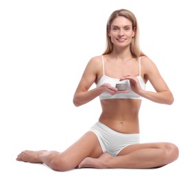 Woman with jar of body cream on white background