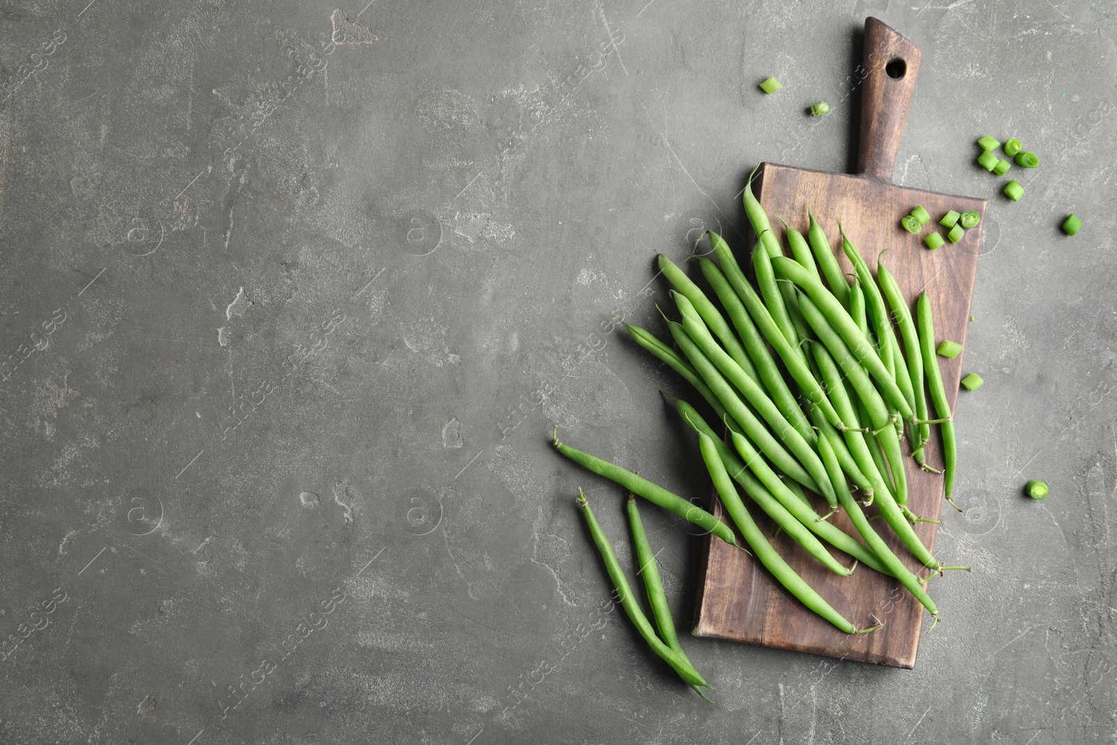 Photo of Fresh green beans on grey table, flat lay. Space for text