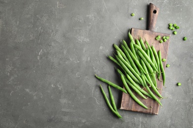 Photo of Fresh green beans on grey table, flat lay. Space for text