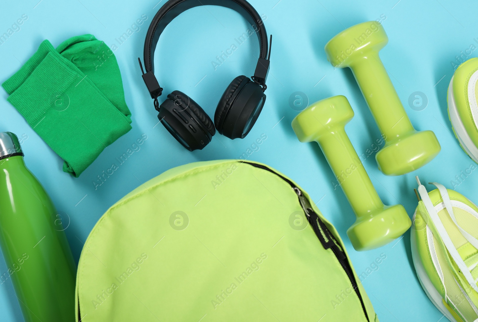 Photo of Different sports equipment on light blue background, flat lay