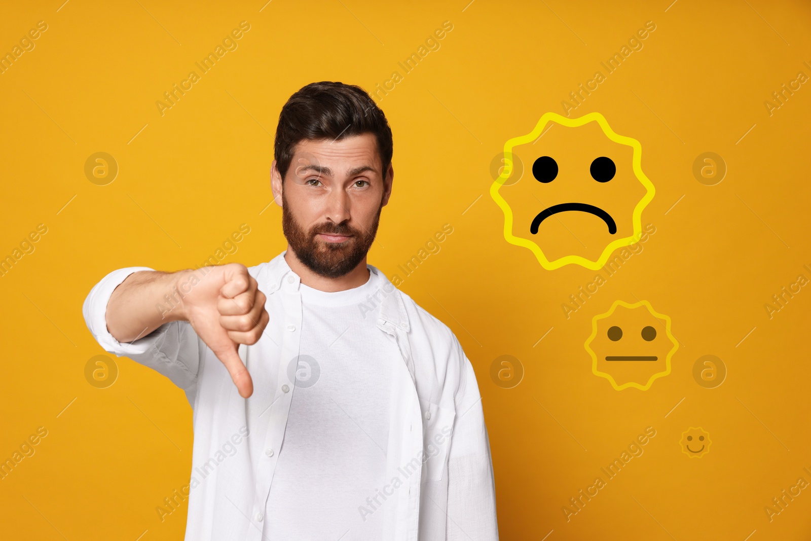 Image of Complaint. Dissatisfied man showing thumbs-down on orange background. Illustrations of sad and neutral faces near him