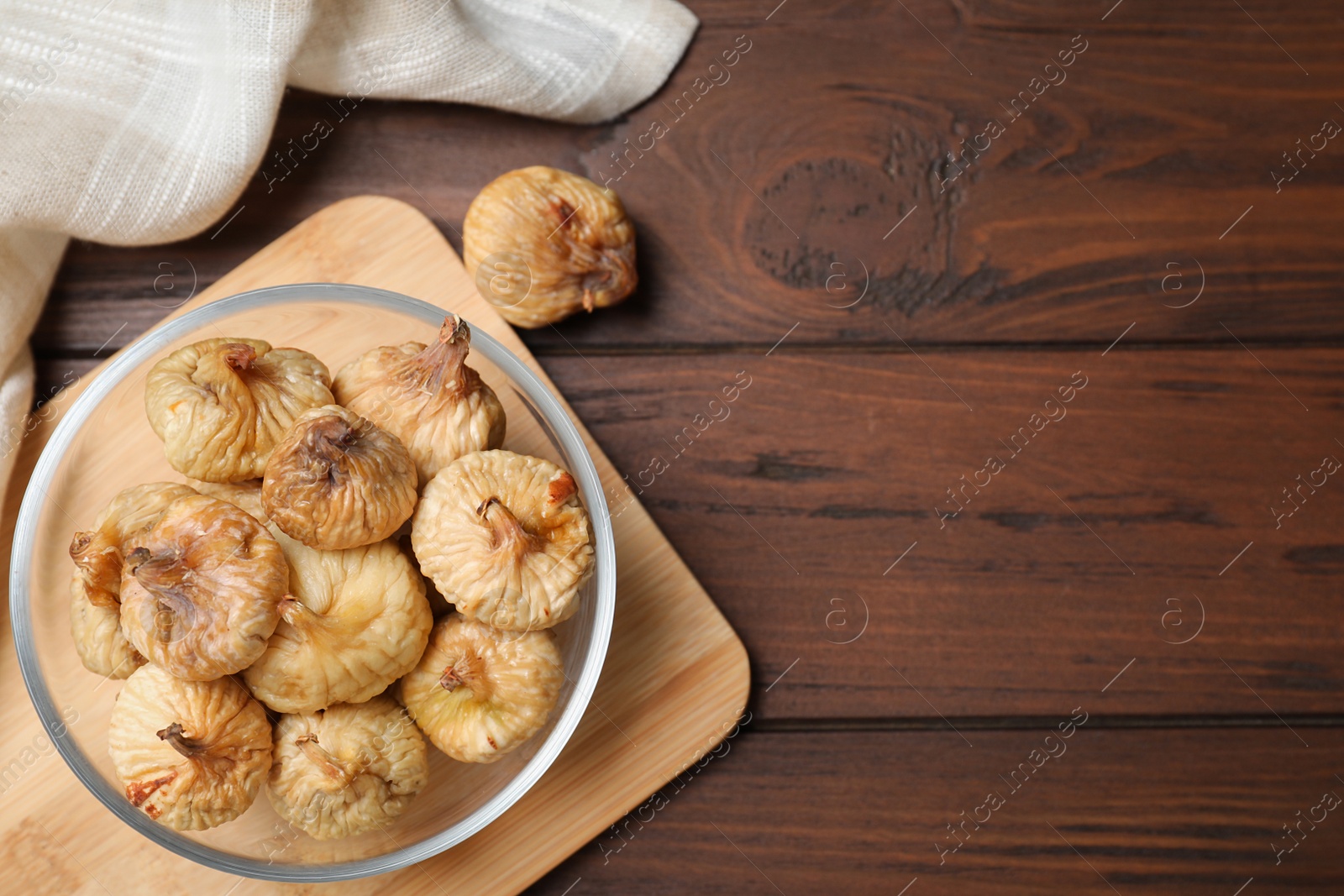 Photo of Tasty dried figs on wooden table, flat lay. Space for text