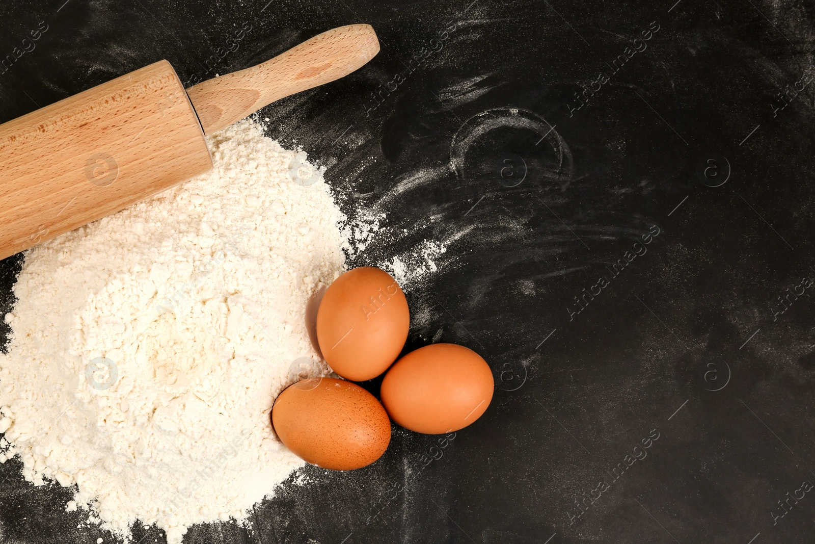 Photo of Flat lay composition with raw eggs on black background, space for text. Baking pie