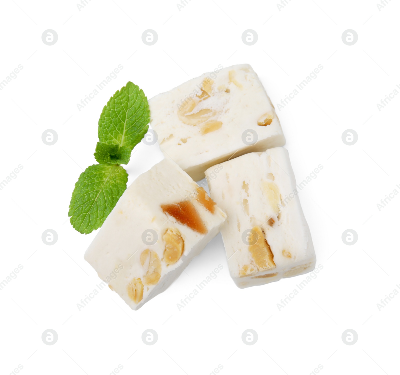 Photo of Pieces of delicious nougat and mint on white background, top view