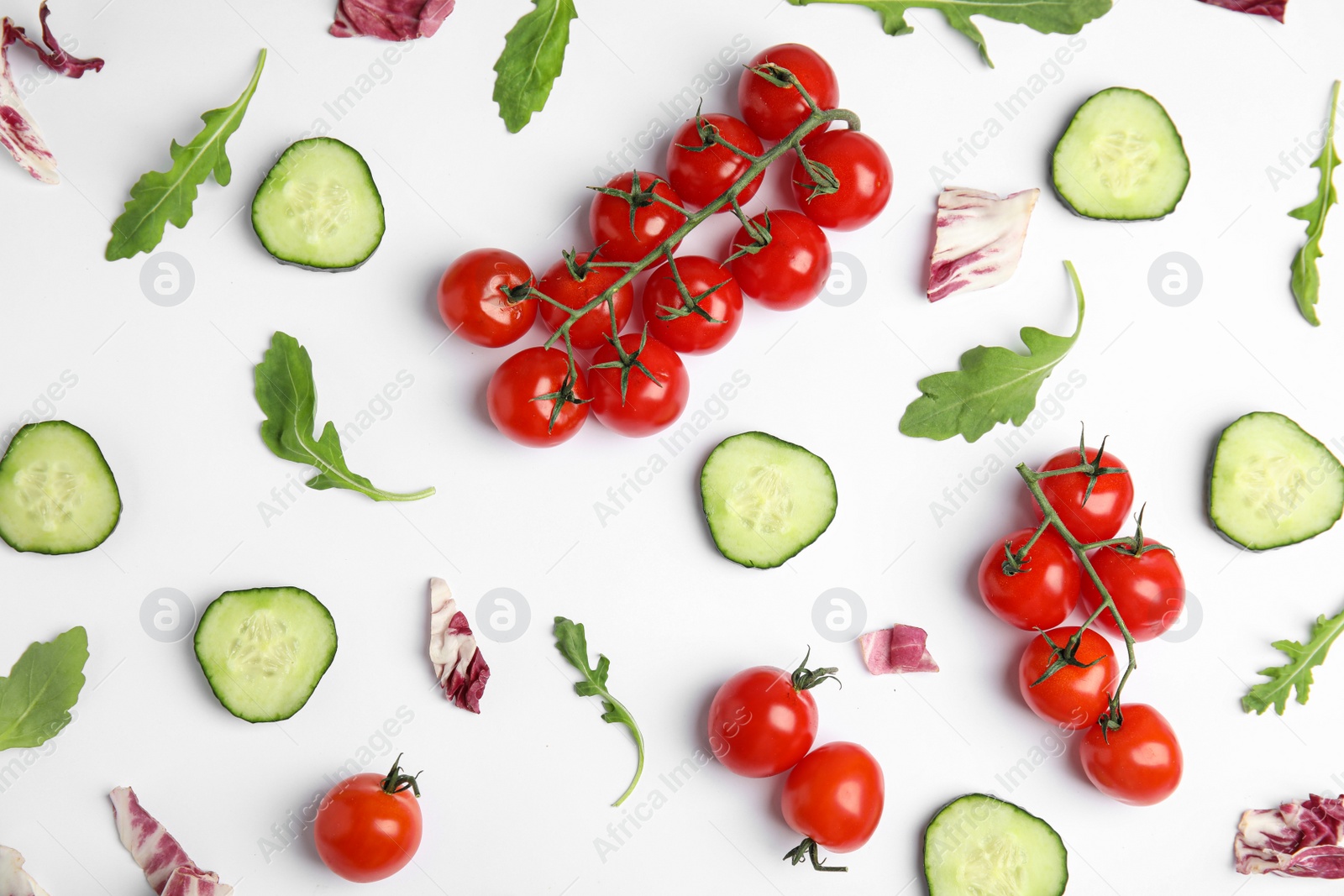 Photo of Fresh vegetables for salad on white background, top view