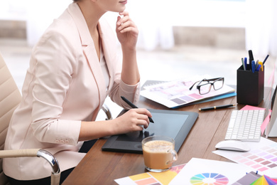 Female designer working at desk in office, closeup