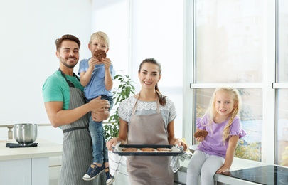 Photo of Happy family with homemade oven baked cookies in kitchen