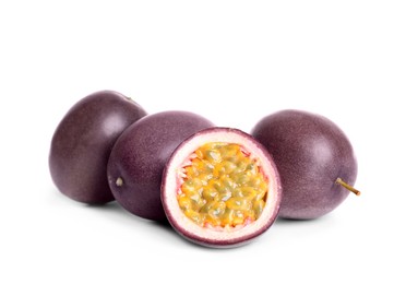 Photo of Cut and whole passion fruits on white background