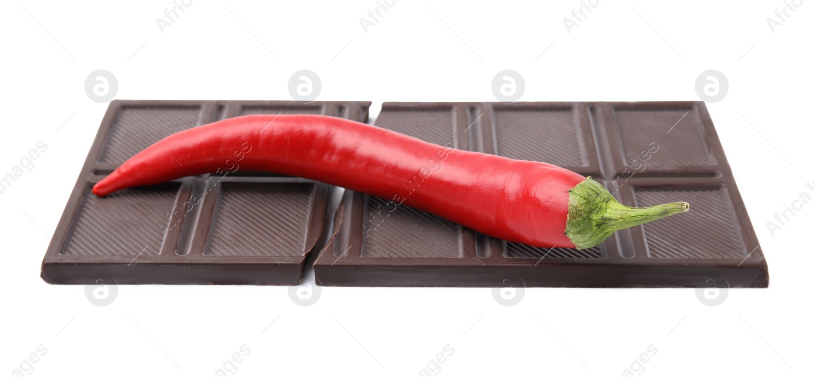 Photo of Dark chocolate bar with red hot chili pepper isolated on white