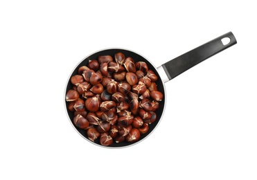 Photo of Delicious sweet roasted edible chestnuts in frying pan isolated on white, top view