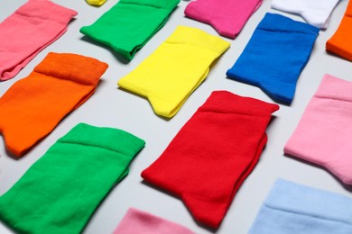 Different textile colorful socks on grey background