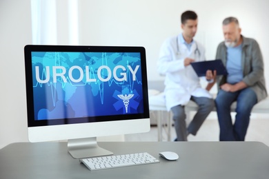 Photo of Computer monitor with word UROLOGY and blurred people on background