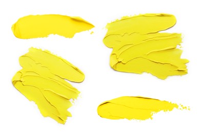 Yellow oil paint strokes isolated on white, top view