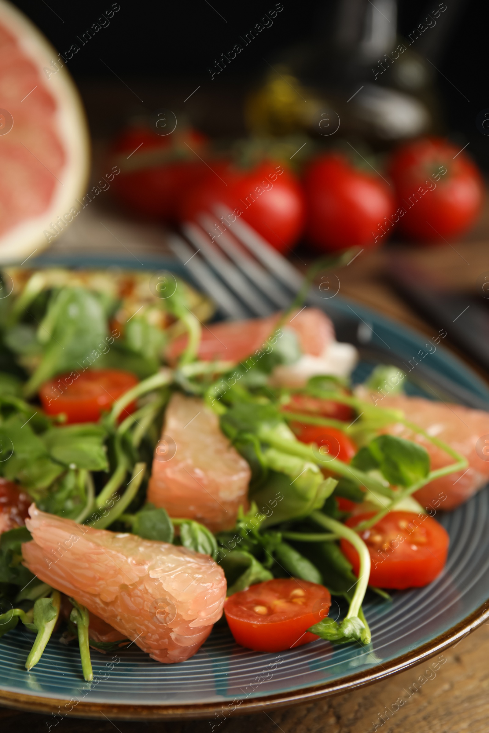 Photo of Delicious pomelo salad served on table, closeup