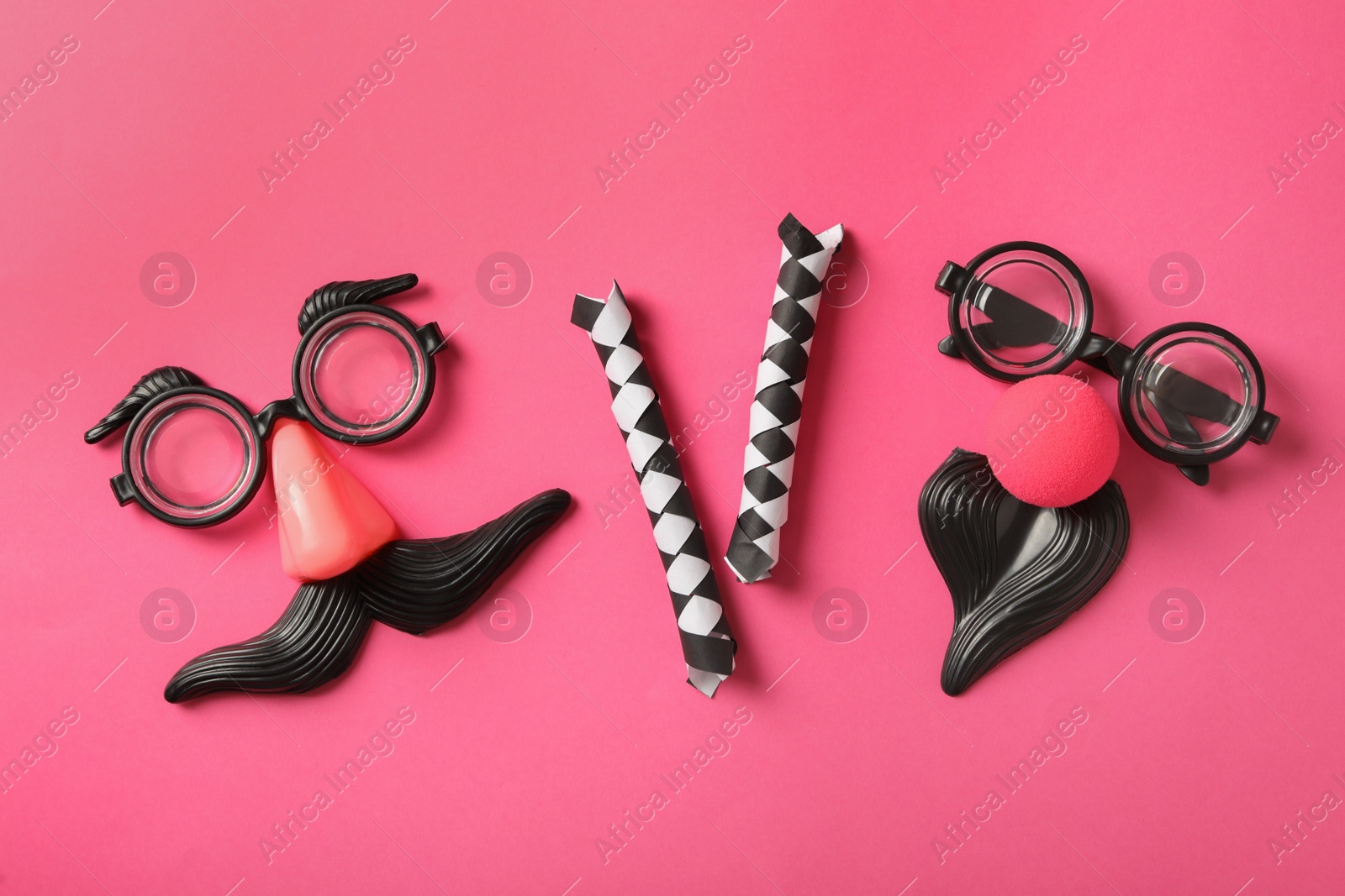 Photo of Funny glasses and decor on pink background, flat lay