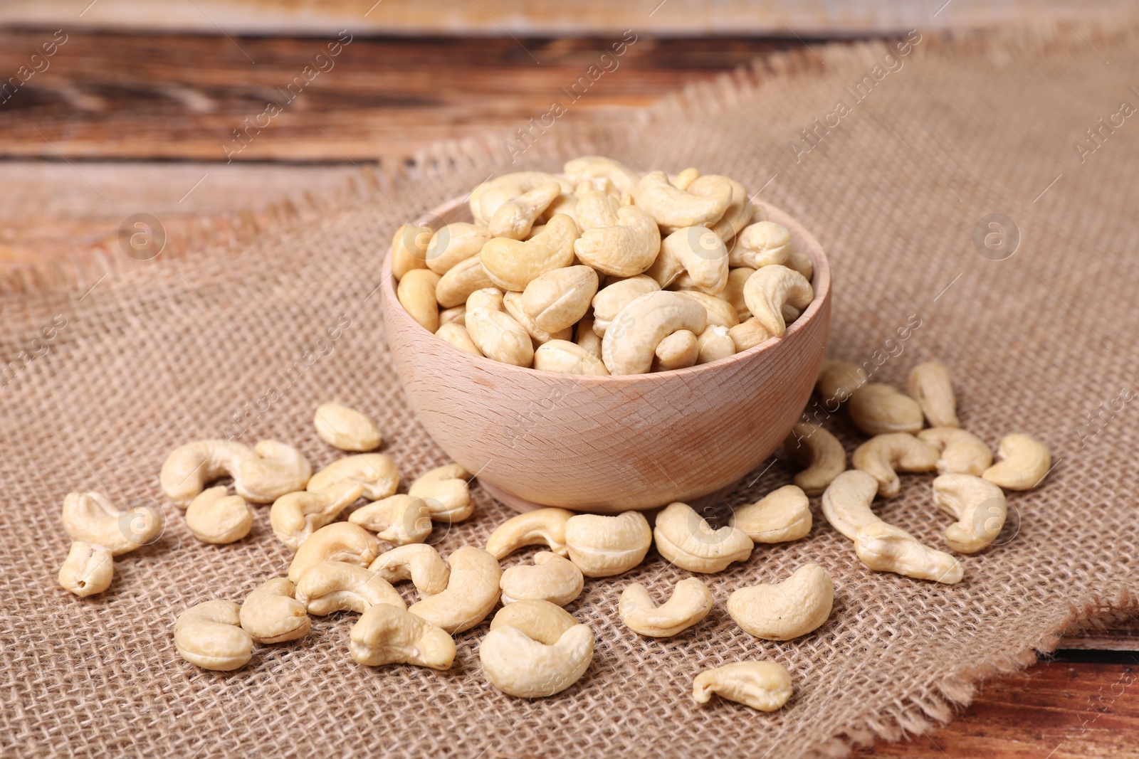 Photo of Tasty cashew nuts in bowl on table