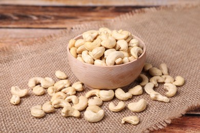 Photo of Tasty cashew nuts in bowl on table