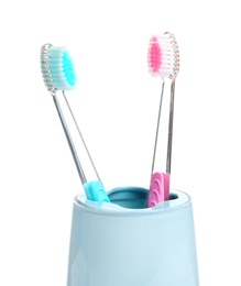 Photo of Cup with toothbrushes on white background. Dental care