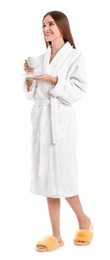 Photo of Young woman in bathrobe with cup of drink on white background