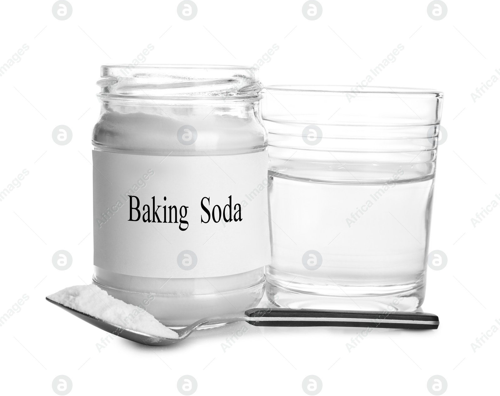 Photo of Glass of water, jar with baking soda and spoon on white background