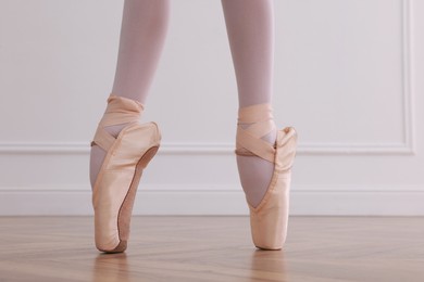 Little ballerina practicing dance moves in studio, closeup of legs