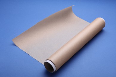 Photo of Roll of baking paper on blue background