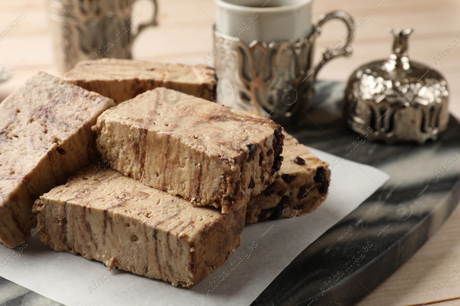 Photo of Tasty chocolate halva on wooden table, closeup