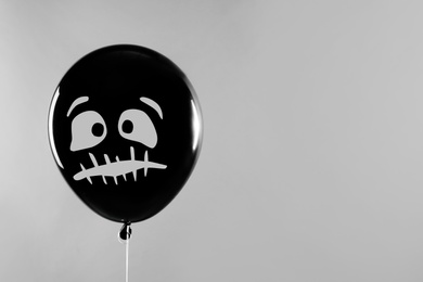 Photo of Spooky balloon for Halloween party on light grey background, space for text