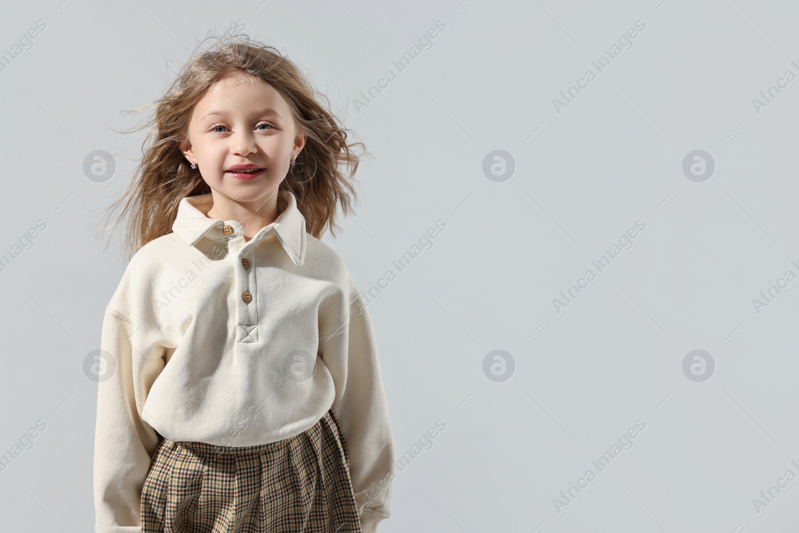 Photo of Fashion concept. Stylish girl posing on light grey background. Space for text