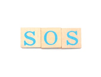 Abbreviation SOS made of wooden cubes on white background, top view