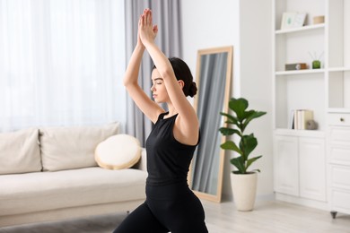 Photo of Portrait of beautiful girl practicing yoga at home