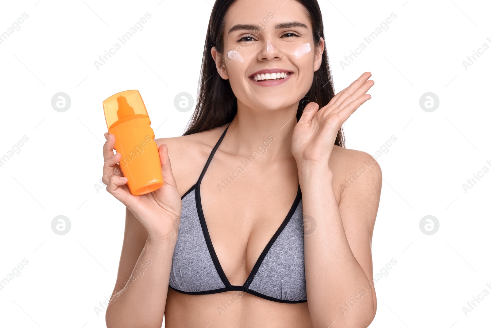 Photo of Beautiful young woman holding bottle of sun protection cream on white background