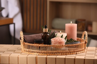 Photo of Beautiful composition with different spa products on wicker bench indoors