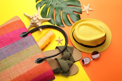 Stylish bag and beach accessories on color background, flat lay