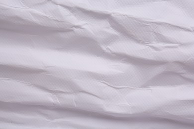 Photo of Texture of crumpled parchment paper as background, top view