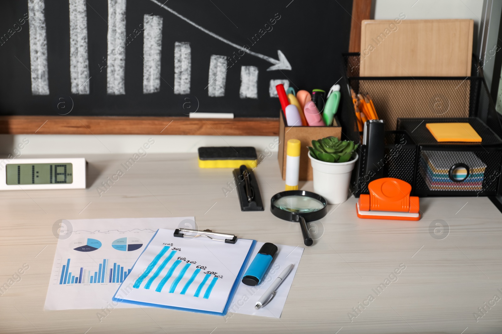 Photo of Business process planning and optimization. Workplace with different graphs and other stationery on wooden table