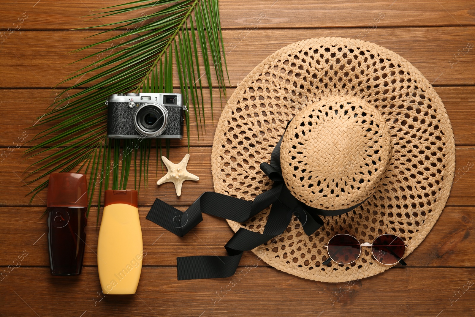 Photo of Flat lay composition with beach objects on wooden background