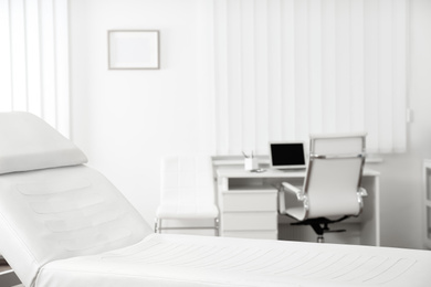 Modern medical examination couch in doctor's office