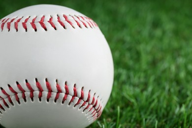 Photo of Baseball ball on green grass, closeup with space for text. Sports game